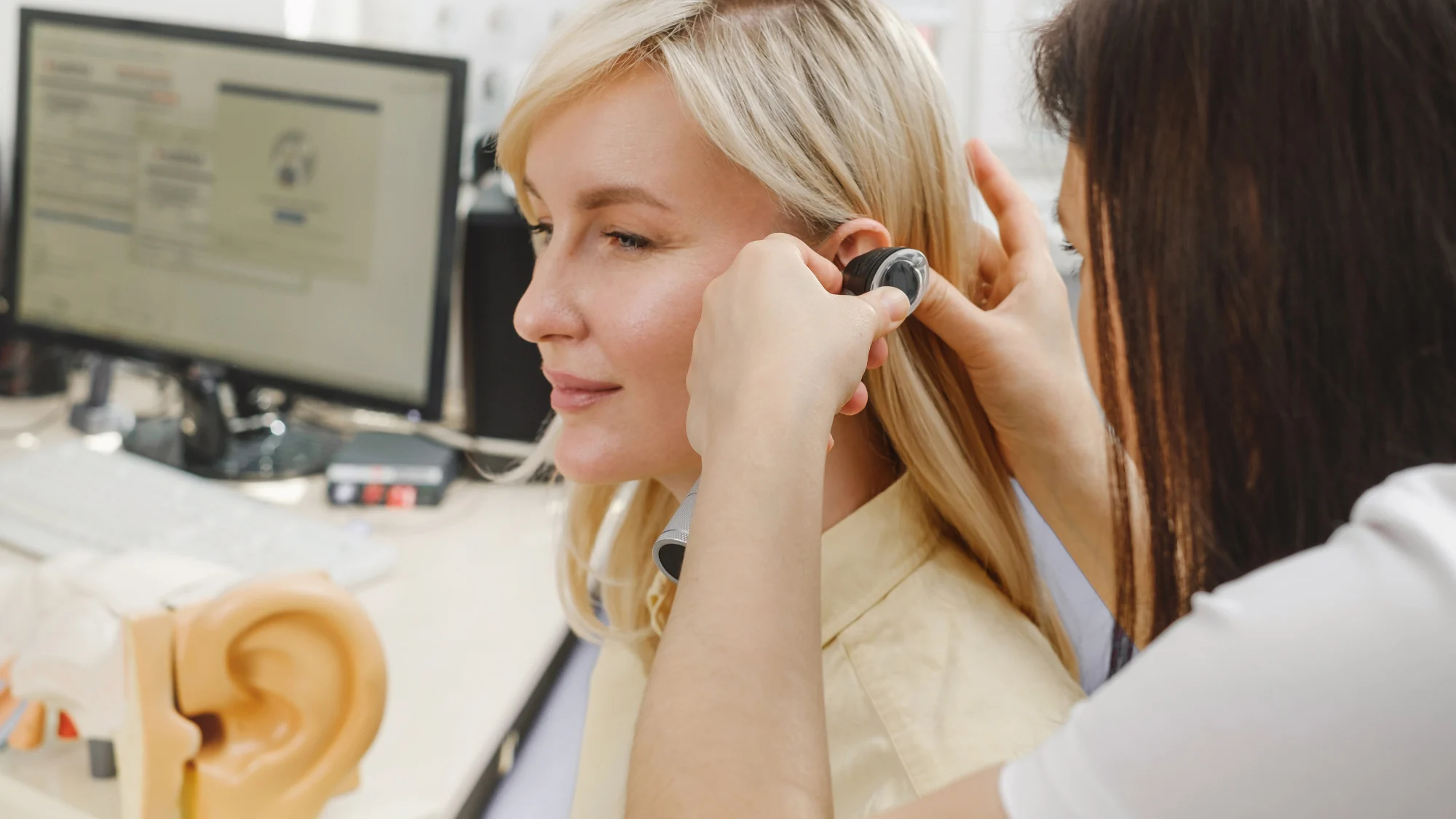 Occupational Hearing Loss and Workers’ Comp in Oregon Audiologist performing a hearing test on a patient to evaluate occupational hearing loss caused by long-term workplace noise exposure.